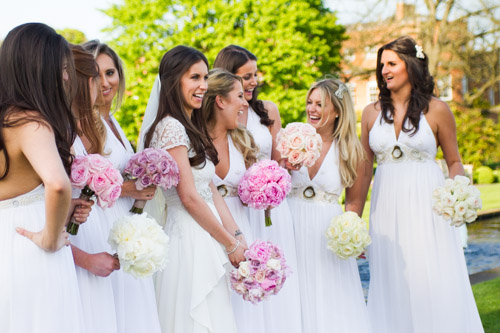 bride wearing a temperley bluebell wedding dress and her bridesmaids with pink and cream bouquets at the grove in hertfordshire