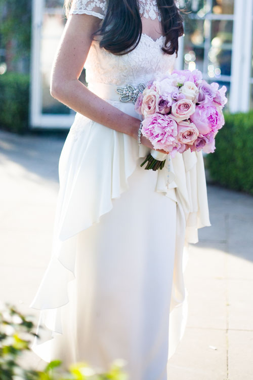 bride in a temperley bluebell wedding dress with a pink bouquet