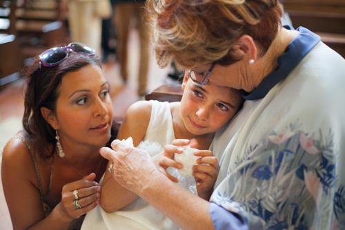 little daughter getting emotional during the wedding ceremony of her parents getting married in ravenna italy