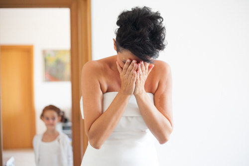 italian bride emotional after putting on her wedding dress on her wedding day in ravenna italy