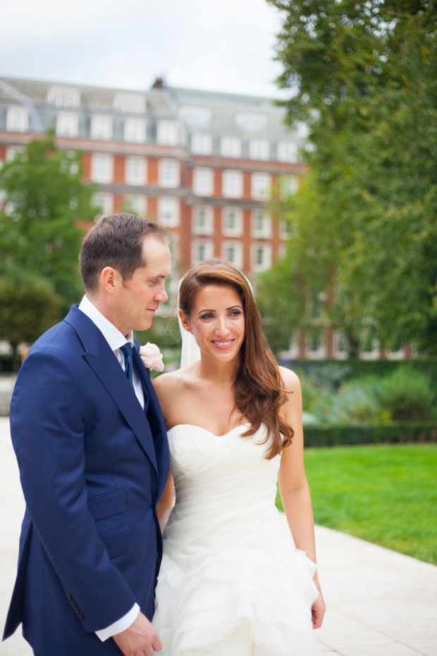 intimate look between a bride and a groom in a park in mayfair during the couple wedding portraits in london