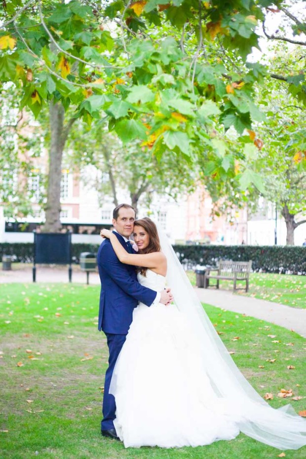 wedding portraits of a luxury couple in a park in mayfair london wearing a vera wang wedding dress