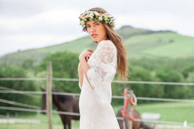 italian bride with a floral crown with horses in the marche region of italy in urbino resort