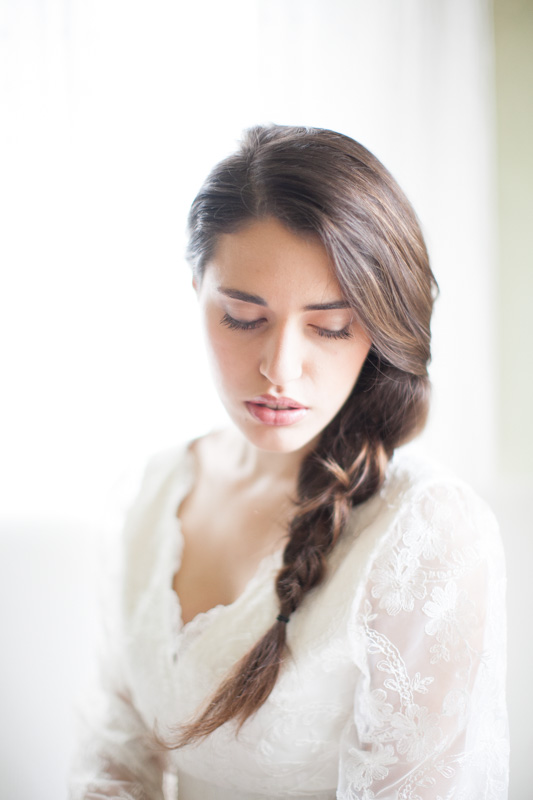soft and romantic portrait of an italian bride with a braid during her wedding preparations in italy