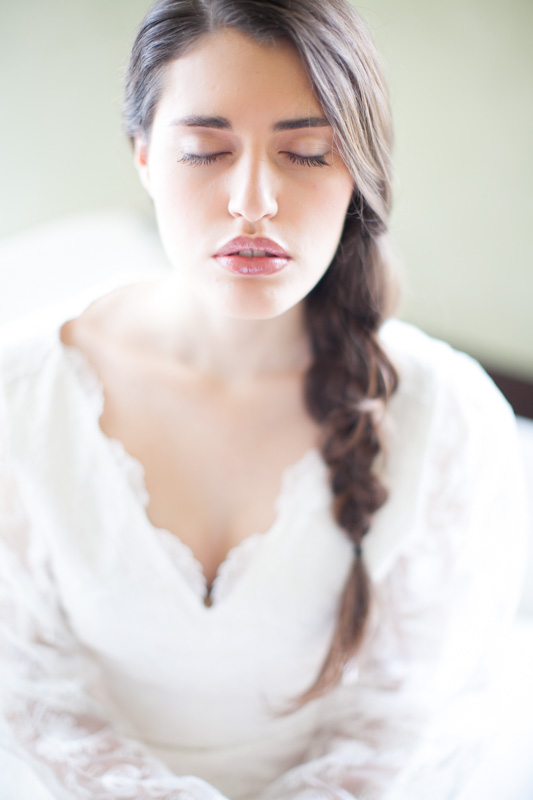 dreamy and ethereal wedding portrait of an italian bride with a braid in a soft and fine art style while she has her eyes closed