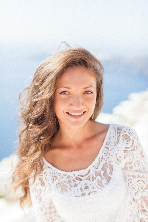 greek bride wedding portrait very soft and romantic with the hair moving due to the breeze at la maltese in santorini