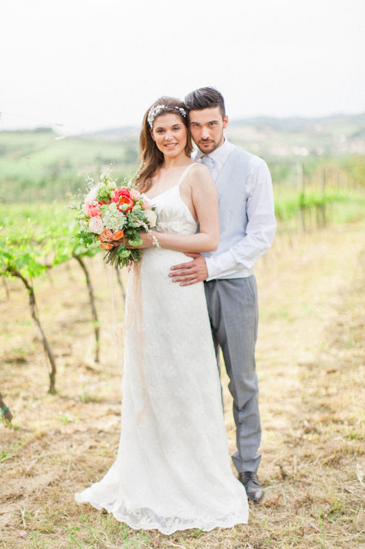 wedding portraits of an italian bride and groom in a rustic vineyard after their wedding day in the marche region of italy at urbino