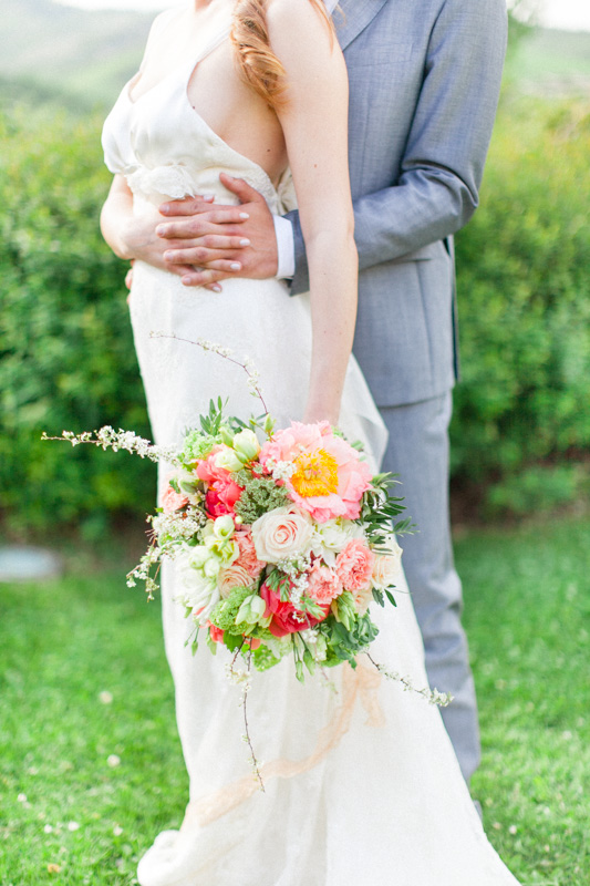 close up portrait of a bride and groom holding hands in italy with a bouquet in the marche region of italy