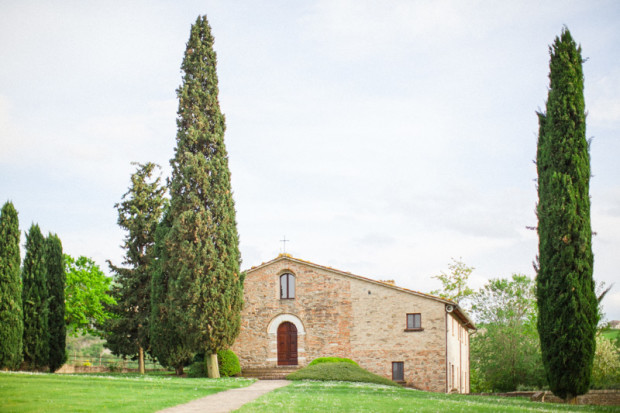 an intimate abbazia for small weddings in italy at urbino resort in the marche region with a field in front of it